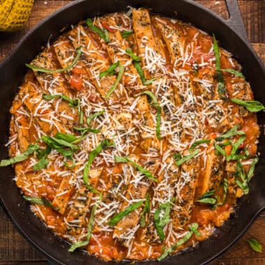 square image of chicken with pomodoro sauce in a cast iron skillet
