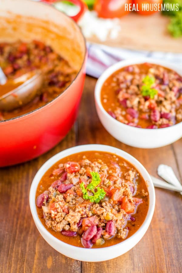 bowls of chili con carne garnished with parsley