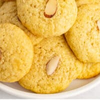 chinese almond cookies piled on a plate with recipe name at the bottom