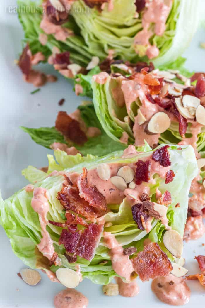 salad topped with chipotle tomato dressing, bacon, and almonds