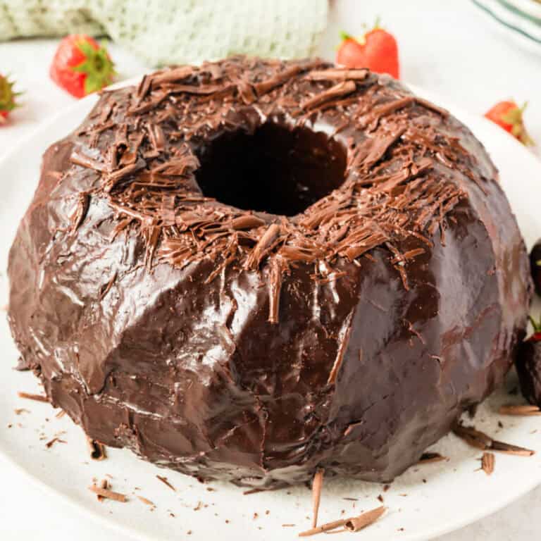 square image of chocolate bundt cake with chocolate shavings on top
