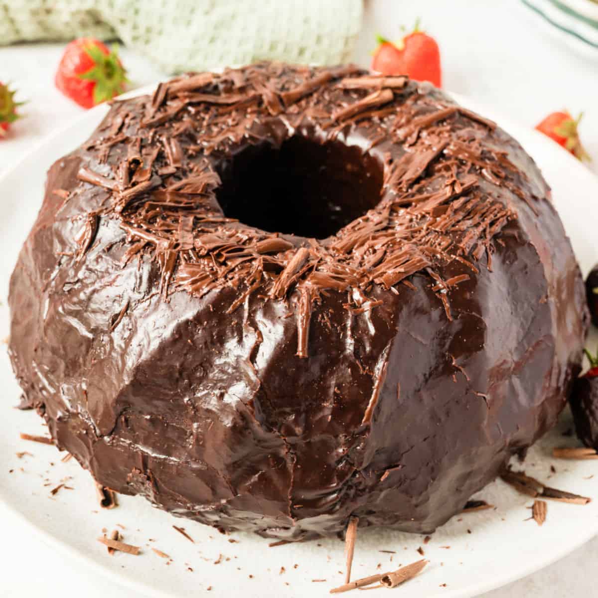 square image of chocolate bundt cake with chocolate shavings on top