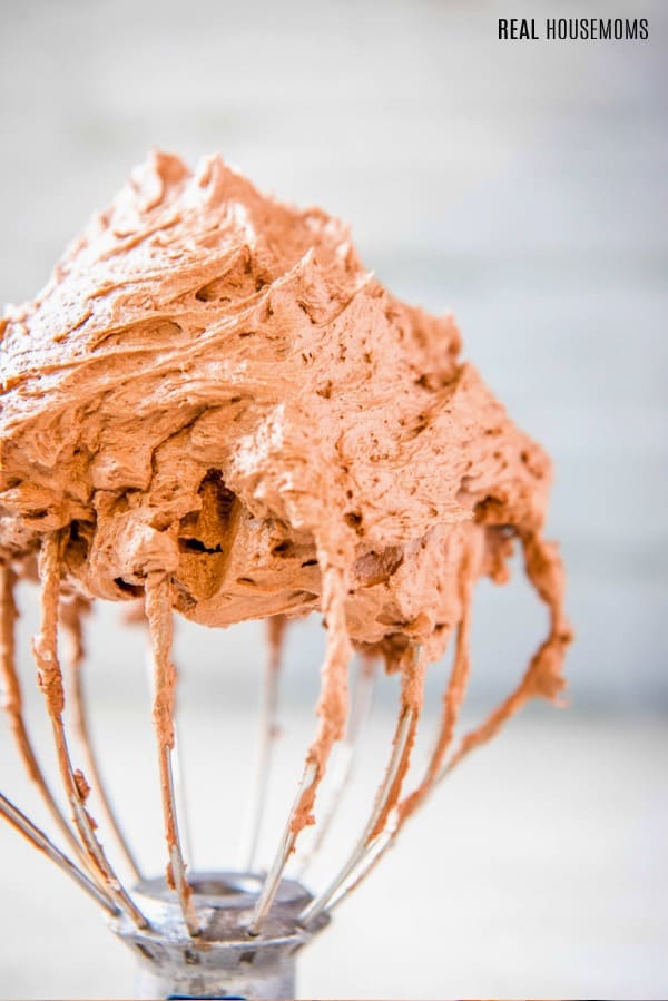 chocolate buttercream frosting on a stand mixer whisk attachment