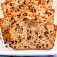 slices of chocolate chip banana bread on a platter with recipe name at the bottom
