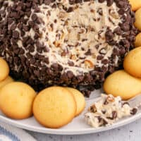 chocolate chip cheese ball with a portion taken out to show the inside with recipe name at the bottom