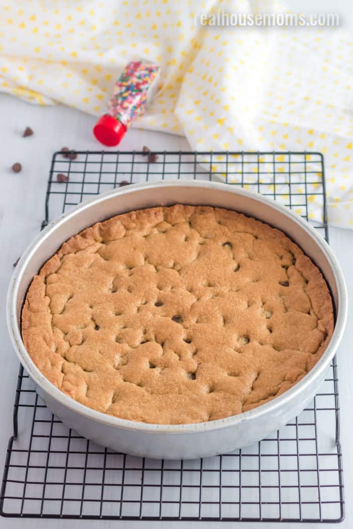cookie cake in a pan on a wire rack