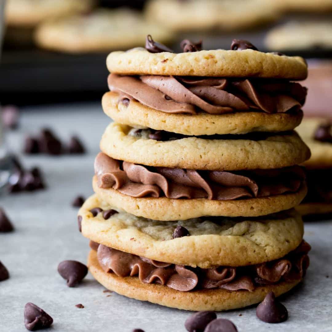 Thin, crisp-edged, chewy-centered chocolate chip cookies sandwiched around a silky chocolate buttercream! These chocolate chip cookie sandwiches are irresistible and utterly delectable!