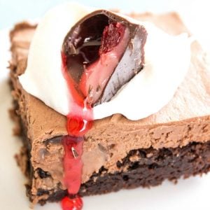 Chocolate Covered Cherry Cheesecake Brownie Bars are decadently delicious. A no-bake cheesecake with a fudgy brownie base these bars are a real crowd pleaser!