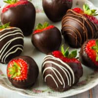 chocolate covered strawberries on a plate with recipe name at the bottom