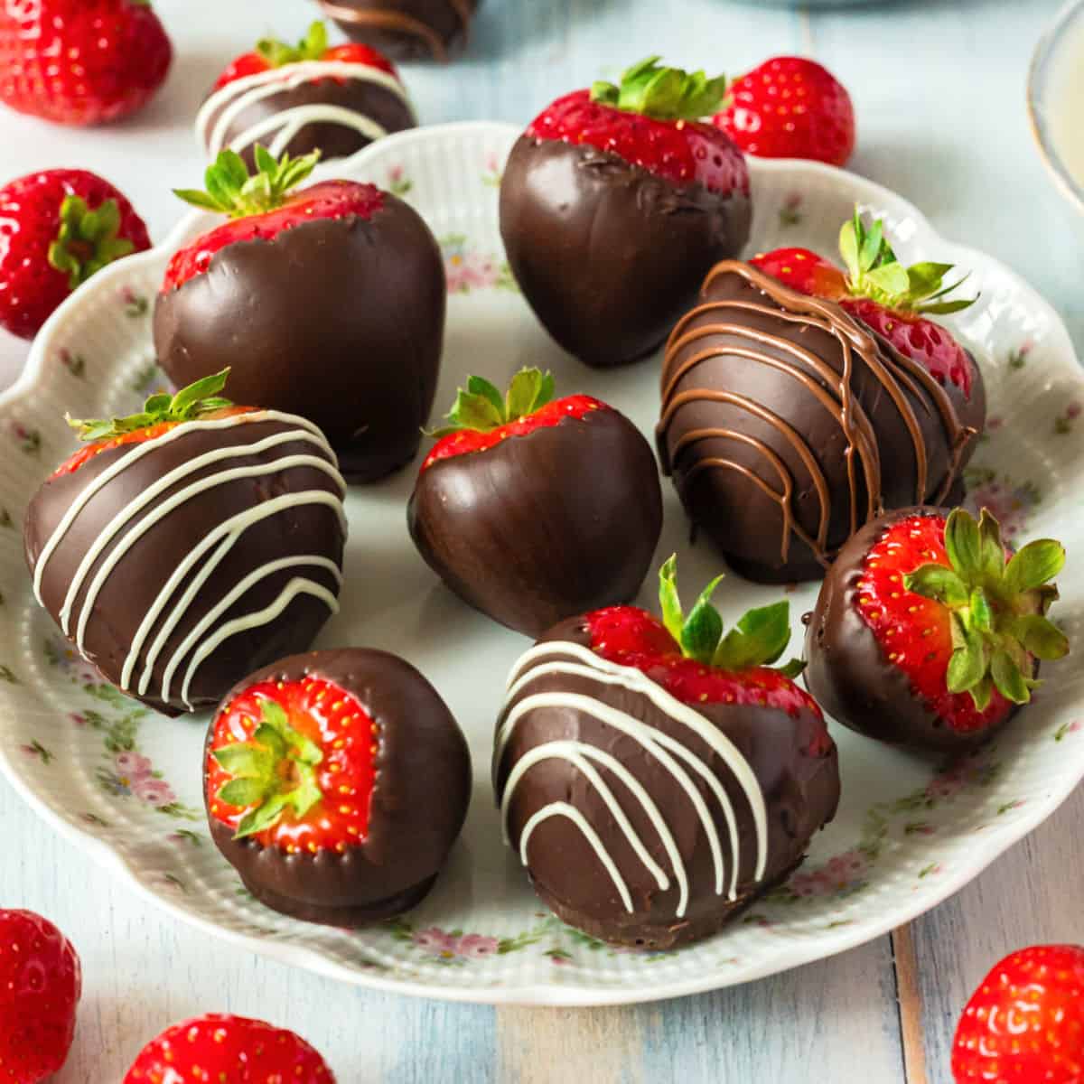 square image of chocolate covered strawberries on a plate