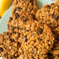 picture of of chocolate peanut butter banana breakfast cookies piled on a plate with the title of the post on top in blue and black lettering