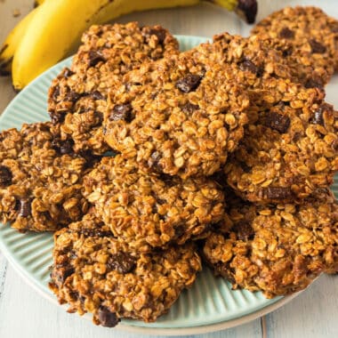 square image of chocolate peanut butter banana breakfast cookies piled on a plate