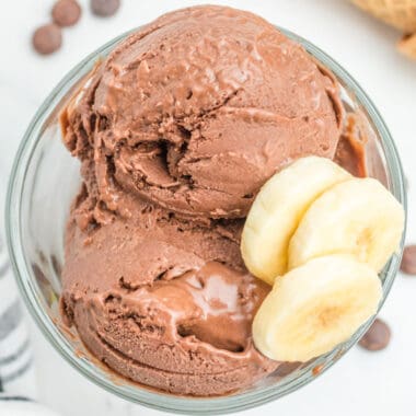 square image of a bowl of chocolate peanut butter banana ice cream with banana slices