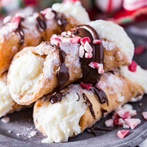 Peppermint whipped ricotta cream filling, a pie crust tube, and delicious chocolate drizzled on top make these easy Chocolate Drizzled Peppermint Cannoli the perfect holiday treat!