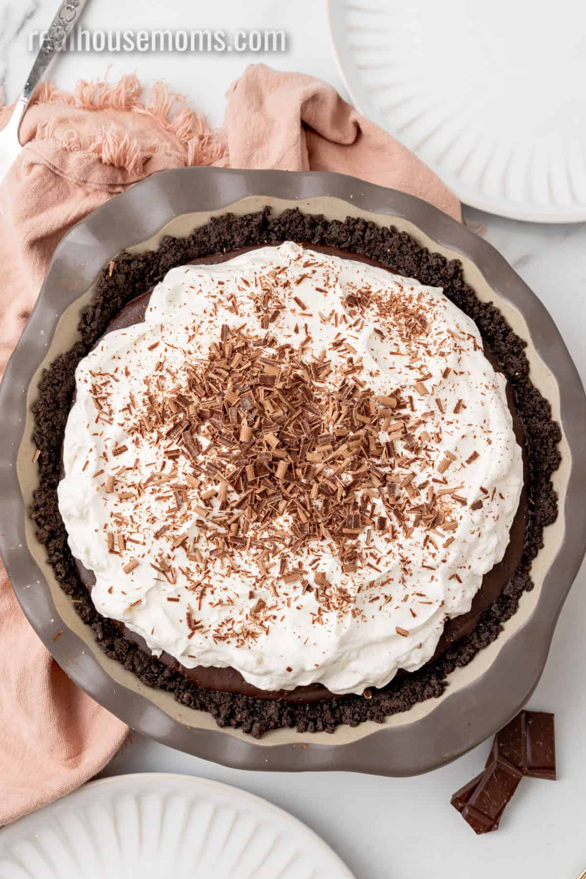looking down at a whole chocolate pudding pie topped with whipped cream and chocolate shavings