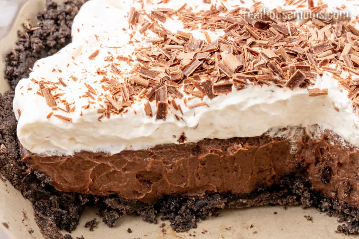 side view of a chocolate pudding pie with a slice taken out to show the layers