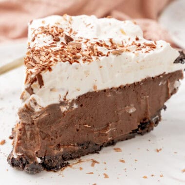 square image of a slice of chilled chocolate pudding pie on a small white plate