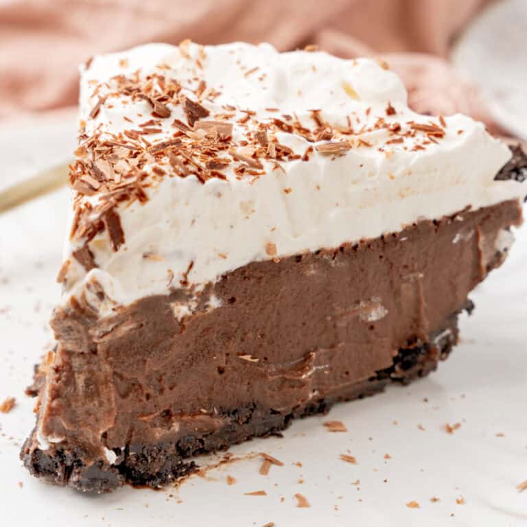 square image of a slice of chilled chocolate pudding pie on a small white plate
