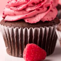 side view of a chocolate raspberry cupcake with recipe name at the bottom