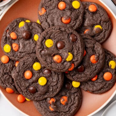 square image of chocolate reese's piece cake mix cookies on a plate