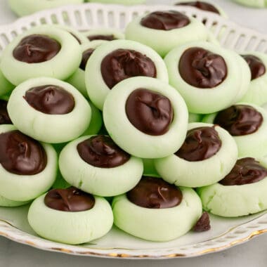square image of chocolate thumbprint cream cheese mints piled on a plate
