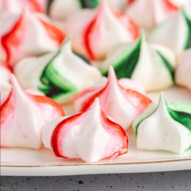 square side view image of Christmas meringue cookies on a platter