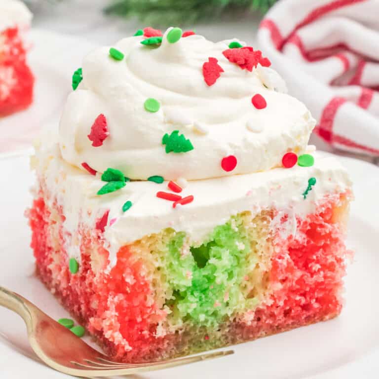 square image of christmas poke cake on a dessert plate