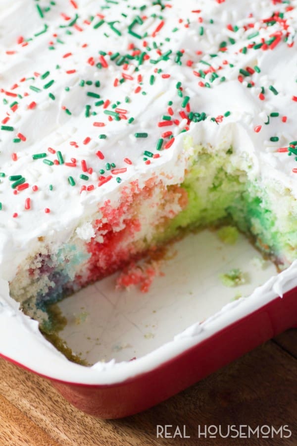 Christmas Rainbow Poke Cake is a fun and colorful cake that makes the holidays even brighter!! Everyone, young and old will love this adorable cake and the kids will be excited to help make it too!