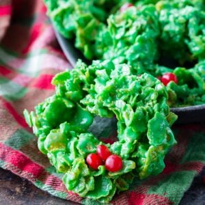 Christmas Wreath Cookies are a festive, fun, and tasty Christmas dessert. These cornflake wreaths are fun to make & easy enough that kids can help too!
