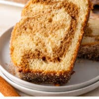 slices of cinnamon donut bread on a plate in front of the loaf with recipe name at the bottom