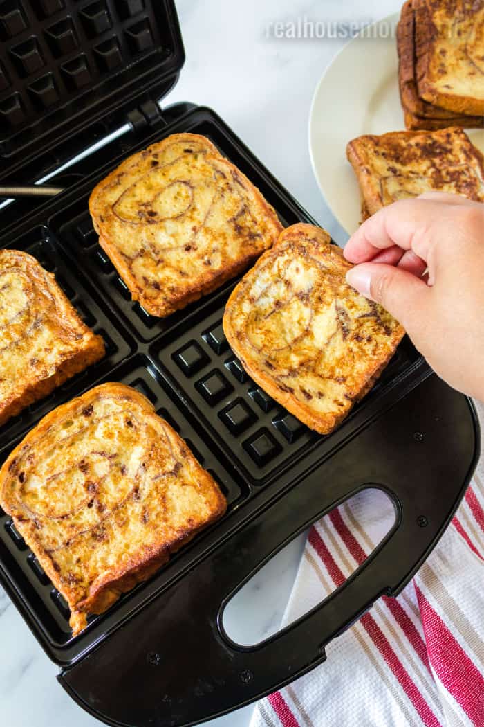 cinnamon french toast being put into a waffle iron