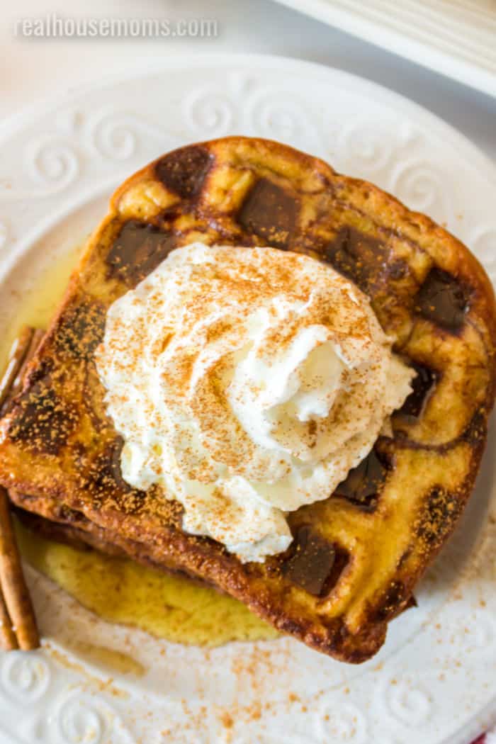 close up of whipped cream on cinnamon french toast waffles