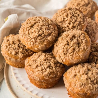 square image of cinnamon muffins piled on a plate