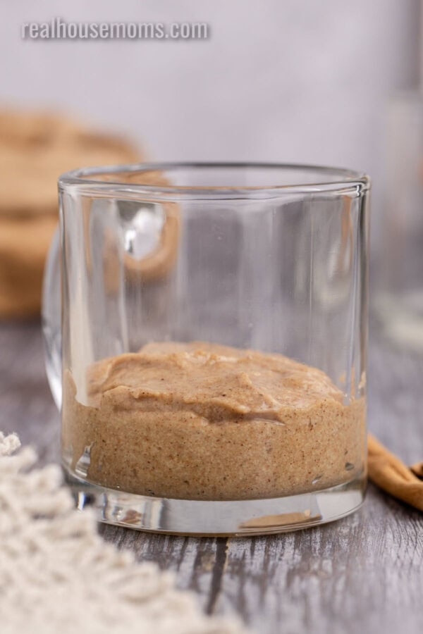 cinnamon roll mug cake batter in a glass mug