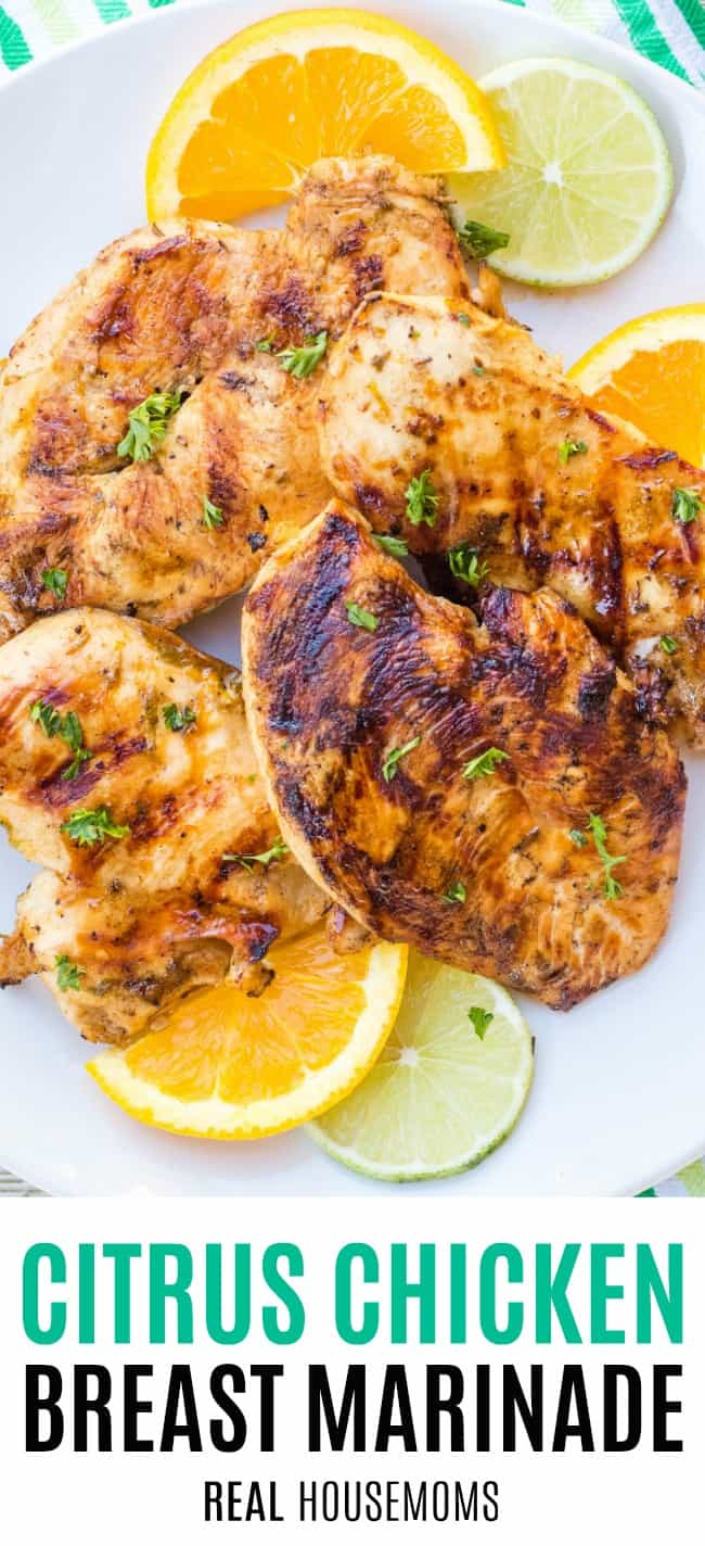 grilled citrus chicken on a platter with orange and lime slices