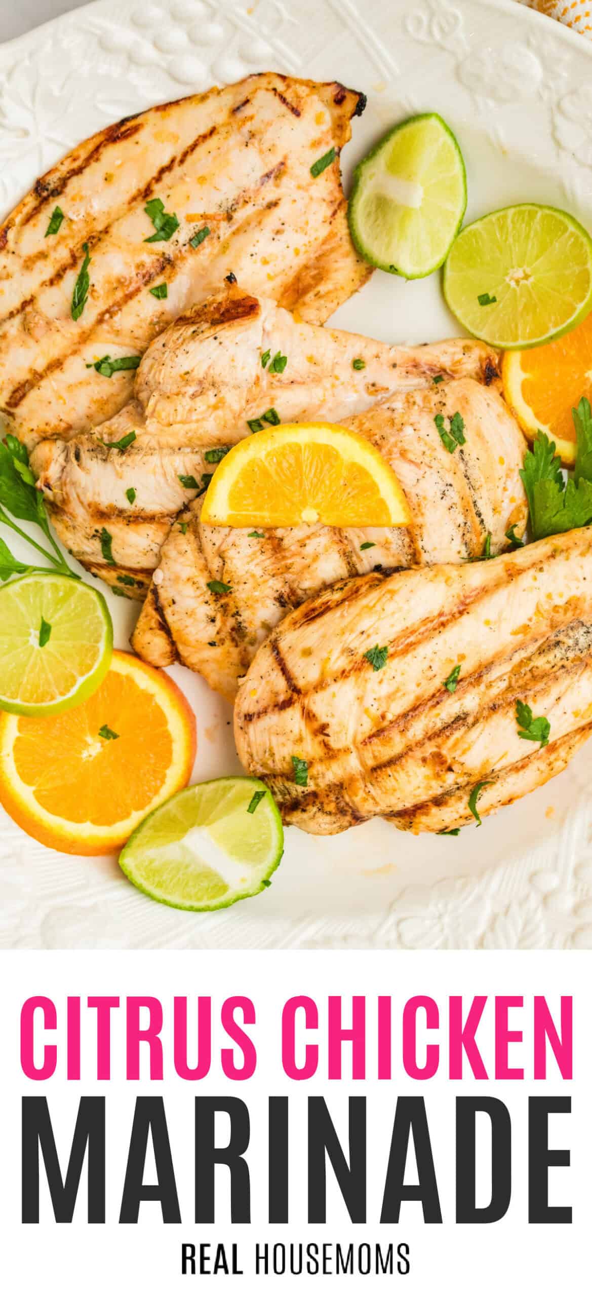 grilled citrus chicken breasts on a platter with orange and limes slices with recipe name at the bottom