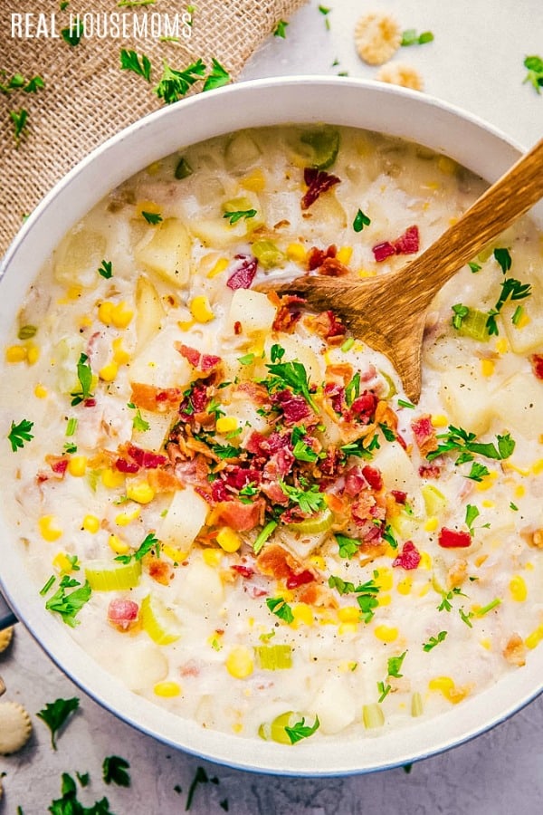 pot of clam chowder garnished with parsley and bacon