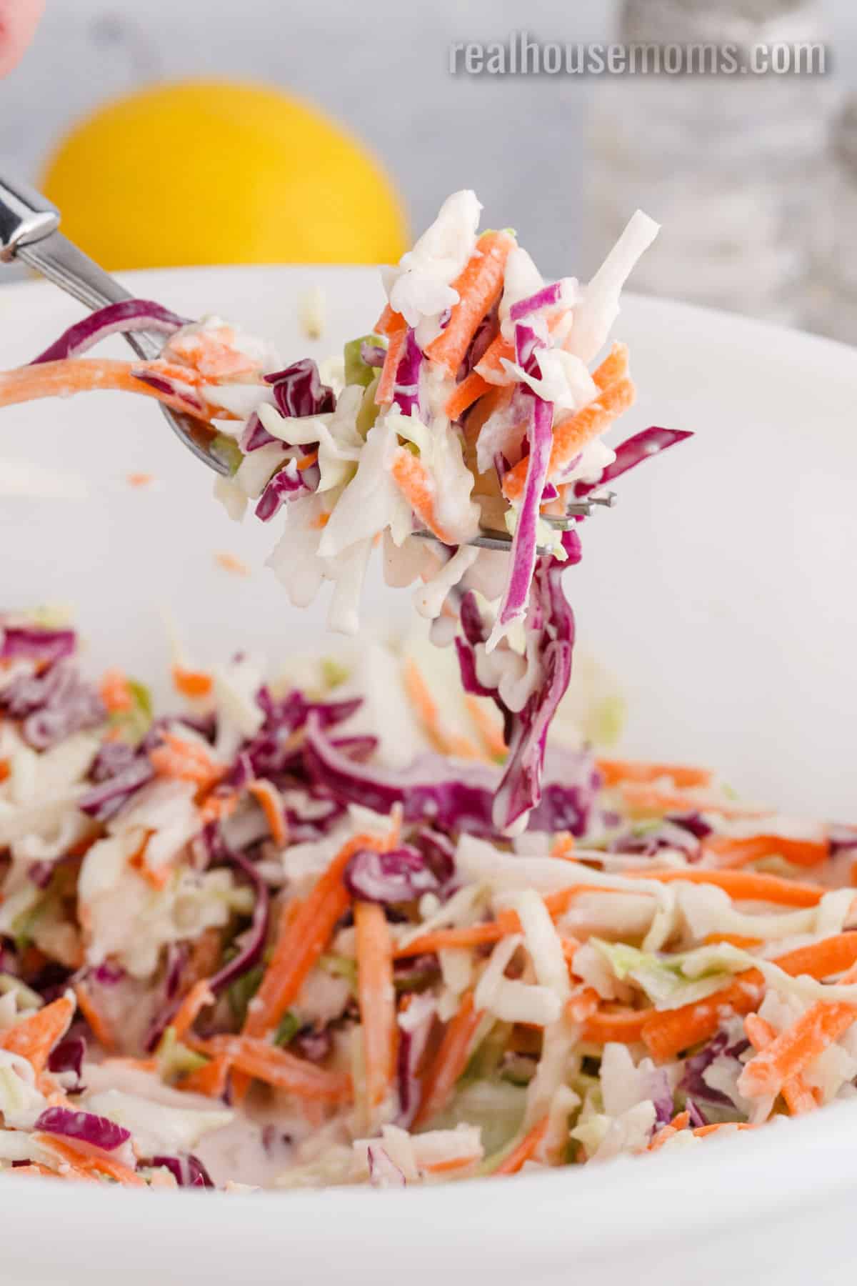 forkful of classic coleslaw over the bowl
