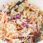 square image of classic coleslaw in a bowl with tongs