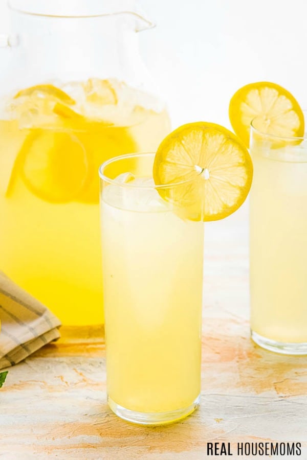 glass of lemonade garnished with a slice of lemon
