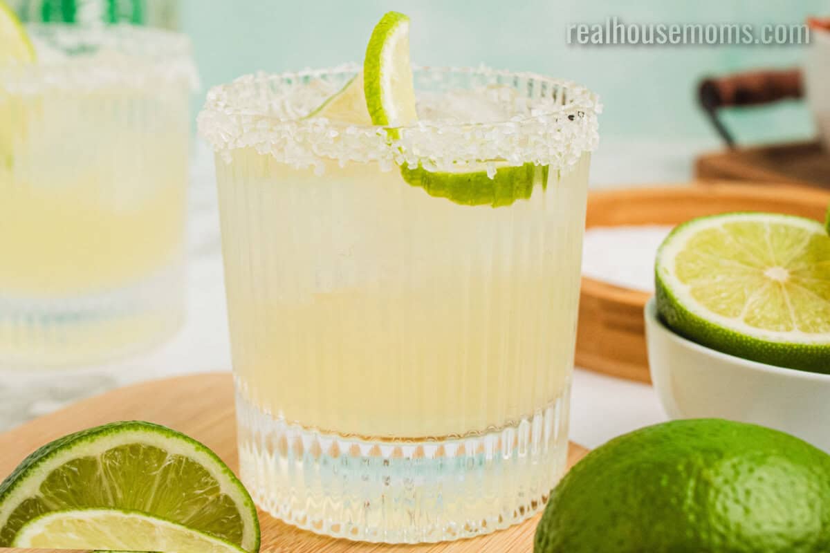 classic margarita in a rocks glass with a twisted lime wheel for garnish