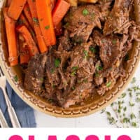 classic pot roast shredded on a platter with potatoes and carrots with recipe name at the bottom