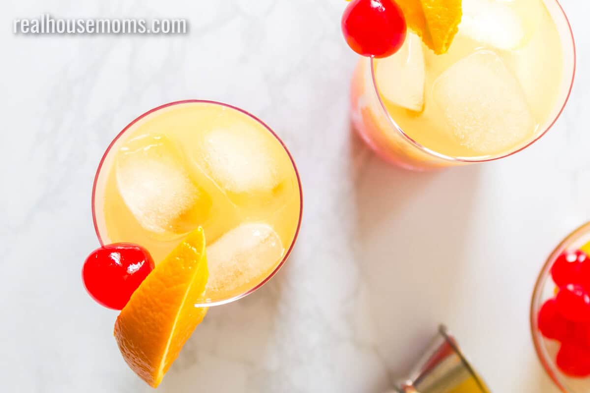 looking down at two tequila sunrise drinks