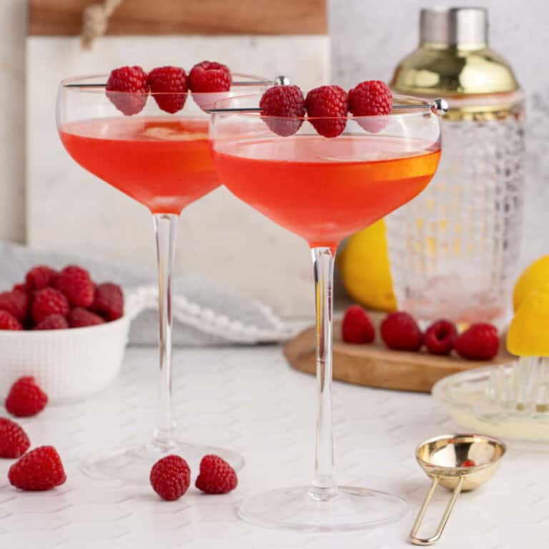 square image of clover club cocktails garnished with raspberries