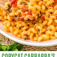close up of a spoonful of copycat carrabba's cavatappi amatriciana over the bowl with recipe name at the bottom