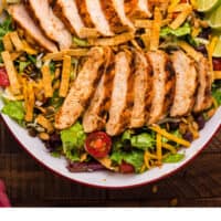 copycat chick fil a spicy southwest salad in a large serving bowl with recipe name at the bottom