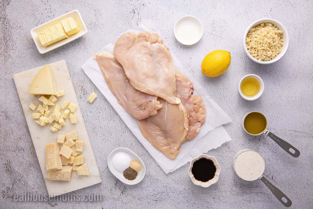 looking down at ingrerdients to make Copycat Longhorn Parmesan Crusted Chicken laid out on a counter