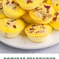 copycat starbucks bacon & gruyere egg bites piled on a plate with recipe name at the bottom