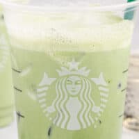 image of a copycat starbucks matcha latte with a green straw with the title of the post on top of the image in pink and balck lettering