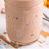 copycat wendy's frosty in a mason jar with fries in the background with recipe name at the bottom
